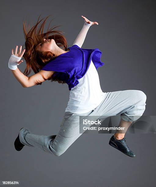Dancer Jumping On Gray Background Stock Photo - Download Image Now - 20-29 Years, Activity, Adult