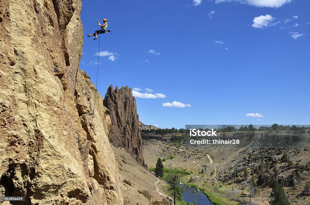 Rock Climber Rappelling "A climber rappels from a cliff at Smith Rock State Park, Oregon." Smith Rock State Park Stock Photo