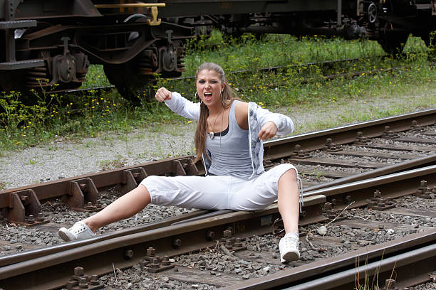 istock emotional woman on railroad tracks 182856733