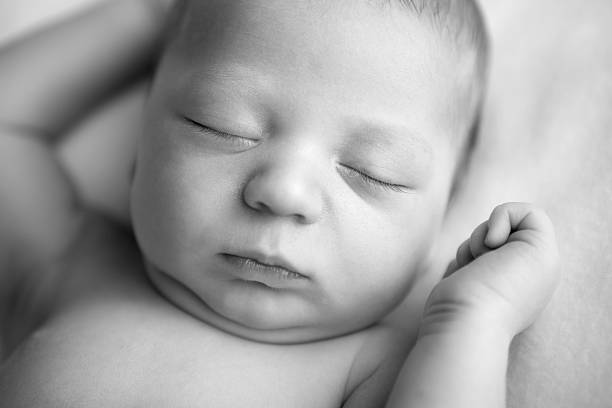 istock Newborn Baby Sleeping Peacefully on Soft Blanket 182856960