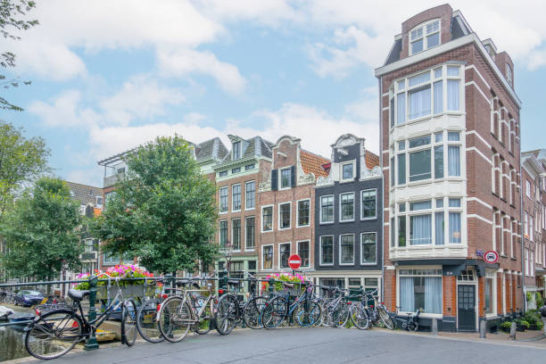 istock Several Bicycles on the Amsterdam Bridge and Building Facades 1828571949