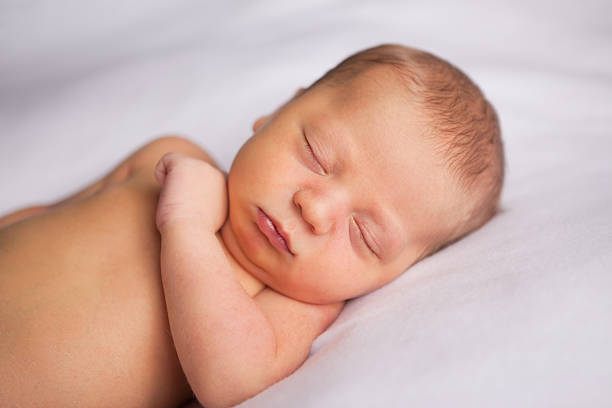 istock Newborn Baby Sleeping Peacefully on Soft Blanket 182857328
