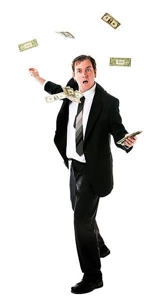 istock Spinning businessman with money flying round him 182857335