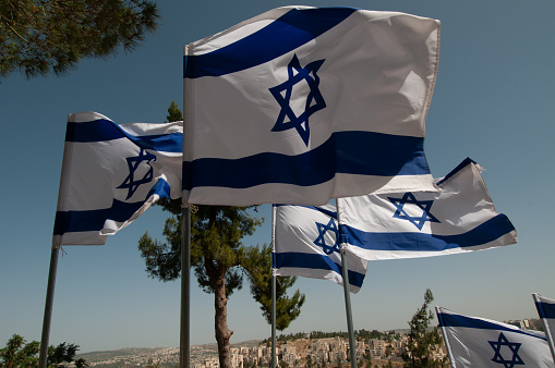 Multiple blue and white Israeli flags on display during the annual Independence Day celebration in spring.