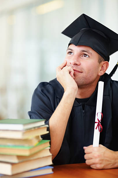 istock Contemplative young man holding graduation certificate 182857997