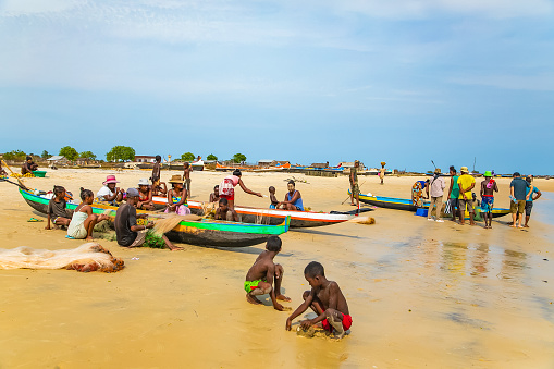 Batavia,western Madagascar, Toliara province.18 october 2023. Inhabitants Madagascar traditional fishing village fold their nets after small catch on ocean shore