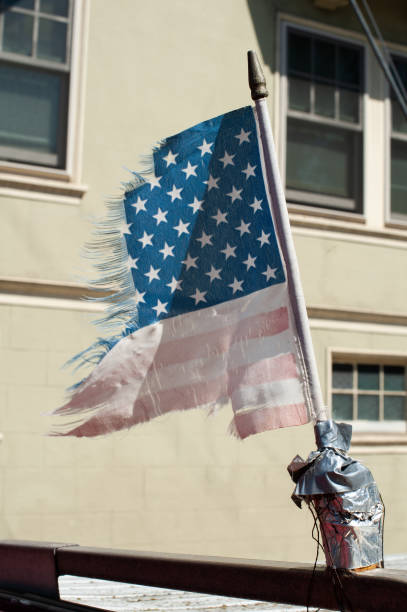 istock Closeup of an aged, torn, ragged American flag 1828581130