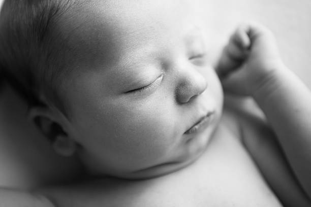 istock Newborn Baby Sleeping Peacefully on Soft Blanket 182858314
