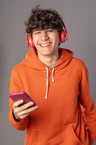 istock Joyful Young Man Laughing with Smartphone 1828586536