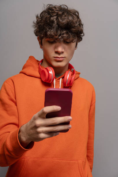 istock Thoughtful teen browsing on smartphone 1828586541