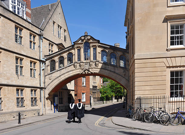 Oxford University Graduates "Oxford UniversityHertford Bridge, popularly known as the Bridge of Sighs, is a covered bridge over New College Lane in Oxford, England.The bridge links together the Old and New Quadrangles of Hertford College and is a famous Oxford landmark." oxford university photos stock pictures, royalty-free photos & images