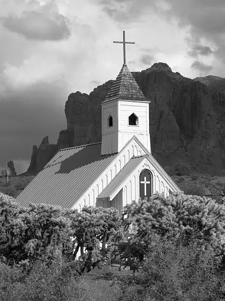 "Elvis Presley Memorial Church in black and white.  The Elvis Memorial Chapel is a movie memorabilia museum showing the movies that were filmed at Apacheland.Survivor of two fires, one in 1969 and one in 2004, which decimated Apacheland Movie Ranch, the Elvis  Memorial Chapel was donated to the Superstition Mountain Museum by Sue and Ed Birmingham.The chapel was taken down piece by piece, nail by nail, has been reconstructed on the museum ground. The Apacheland Movie Ranch Museum is a special museum of western motion pictures and television that were filmed there over a 45 year period, including aCharro,aA which starred Elvis Presley. Among some of the better known motion pictures filmed at Apacheland were: The Ballad of Cable Hogue, Arizona Raiders ,The Haunted, The Gambler II and Blind Justice. Television series included Have Gun Will Travel, and Wanted Dead or Alive. It has since it was first constructed served as a wedding chapel."