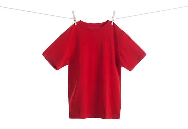 Red Shirt Hanging on a Clothesline This is a photo of a red shirt hanging on a clothesline isolated against a pure white background.Click on the links below to view lightboxes. clothespin wood stock pictures, royalty-free photos & images