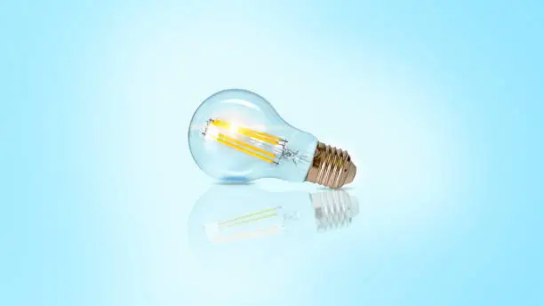 Photo of Creative light bulb abstract on glowing blue background new idea brainstorming concept