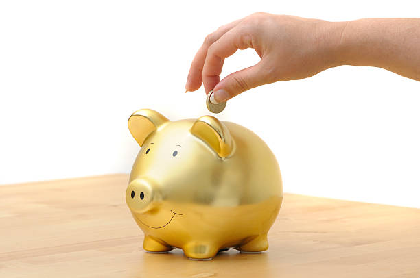 piggy bank - piggy bank gold british currency pound symbol - fotografias e filmes do acervo