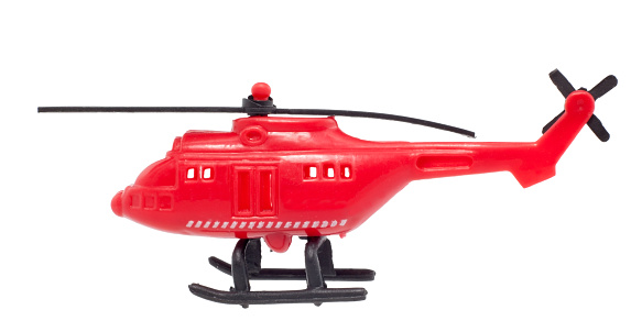 Inexpensive, cheaply made plastic red helicopter. White background. Side view. Horizontal.