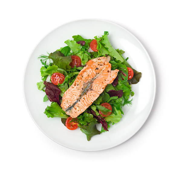 istock White plate with a salmon filet and green salad 182860791