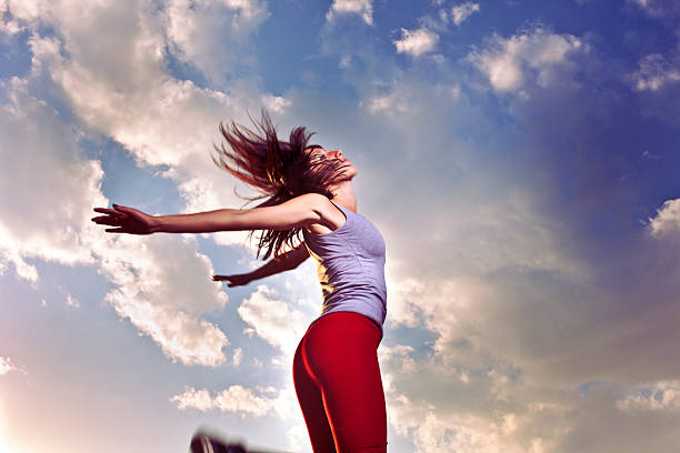 istock Young girl jumping at sunset 182861075