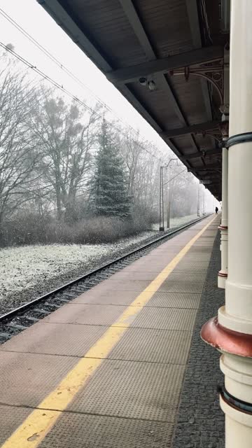 An evocative video showcases a railway station with snow-covered tracks.