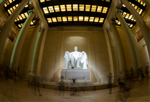 Fisheye shot of Lincoln Memorial in Washington DC. Blurred unrecognizable tourists are visible.--------The seated figure of U.S. President Abraham Lincoln (1809aa1865) sculpted in marble by Daniel Chester French (1850aa1931) was unveiled in 1922. Source: Wikipedia--------