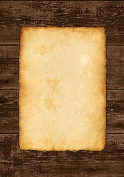 istock old paper on wooden background 182861601