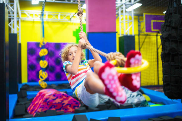 istock Child jumping in trampoline park. Bounce fun. 1828618987