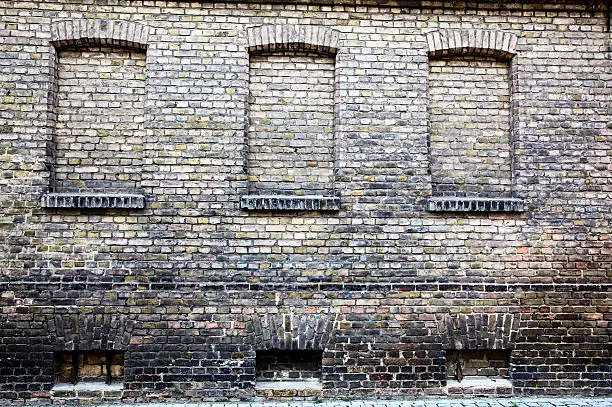 Old brick wall with three bricked-up windows.See also my other textured Backgrounds