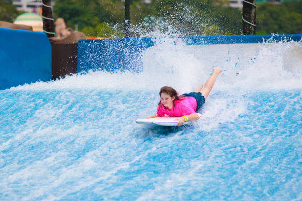 istock Child surfing in wave pool. Surfer training. 1828624881