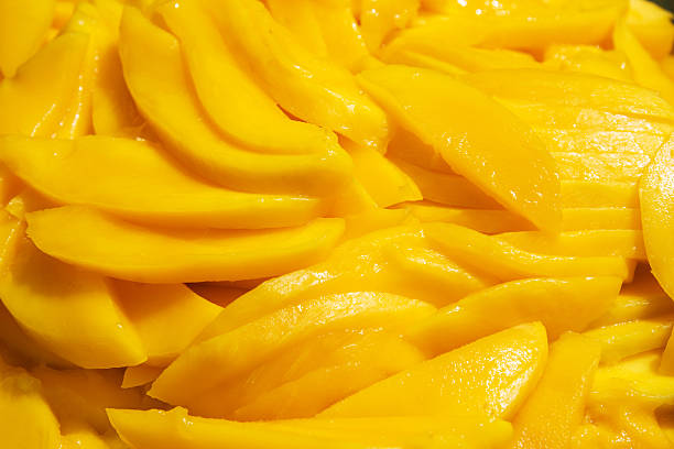 Sliced mangos Fresh Mango slices as a background. mango fruit stock pictures, royalty-free photos & images