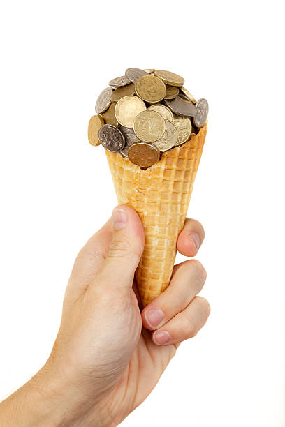 Take a sweet money ice cream. Caucasian hand with Australian coins ball ice cream and waffle cone isolated on white. australian 5 cents stock pictures, royalty-free photos & images