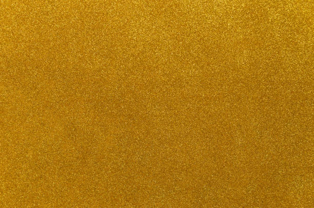 istock Gold colored glitter cardstock paper background 1828631816