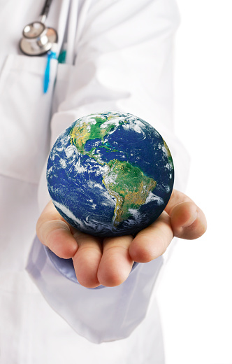 Doctor holding the world in his hands. Concept for global health, diseases, disasters, events, being careful when traveling and similar.