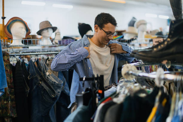 istock Young Man Shop for Retro Clothes at Thrift Store 1828632958