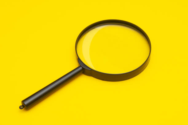 istock Magnifying lens close up on a yellow background 1828633532