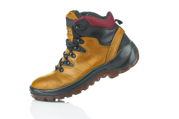 Yellow trekking boot close up  isolated on a white background