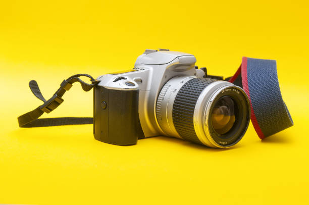 istock Old-fashioned film camera close up on a yellow background 1828633551