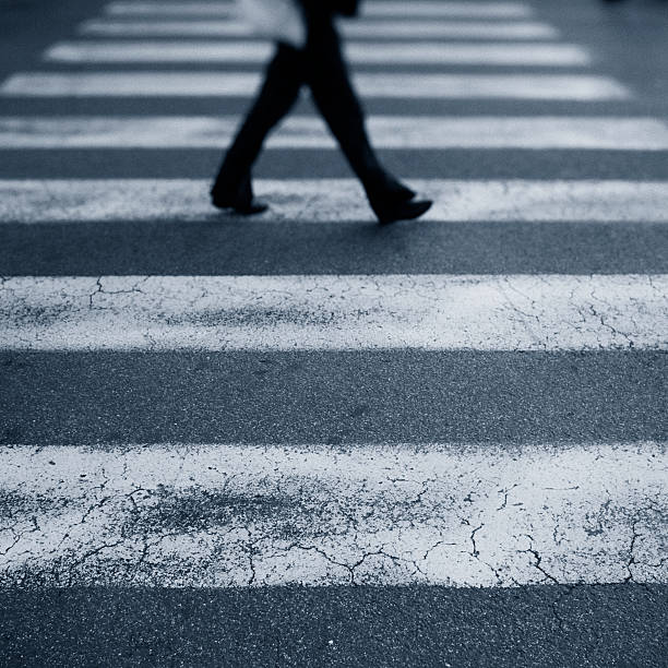 istock Woman Crossing in a Crosswalk 182863657