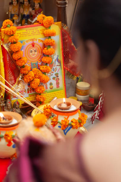 istock An Indian woman performing puja rituals with coconut. 1828640398