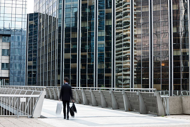 istock Businessman Walking on Elevated Walkway Toward Office Building 182864079