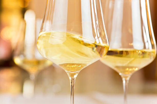 istock Glasses with white wine in a festive room 1828642601