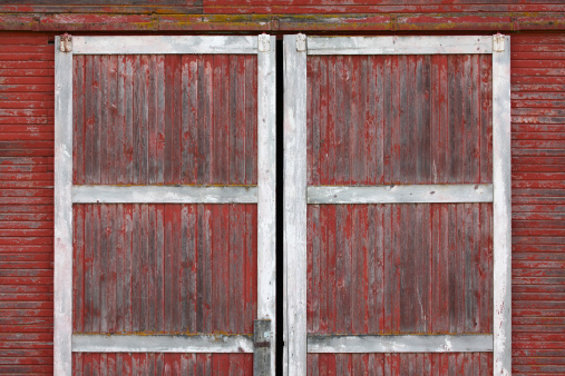 Old hanging/sliding barn doors. Red with white trim.