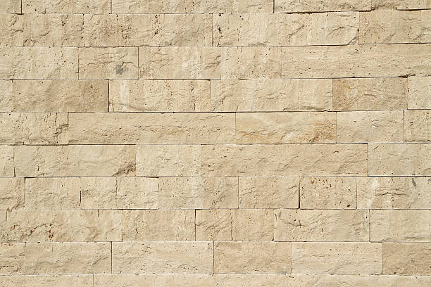 Limestone wall "Horizontal view of a layered, sandstone exterior wall building facade" limestone photos stock pictures, royalty-free photos & images
