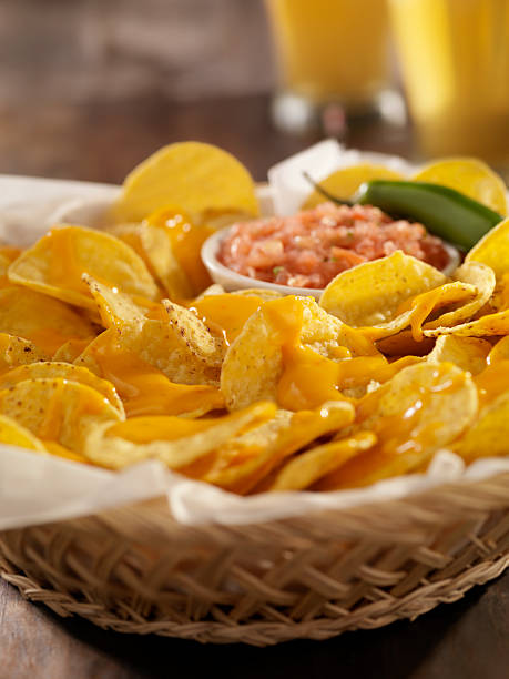 istock Nachos with Cheese Sauce, Salsa and Beers 182864873