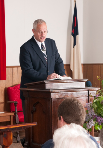 Preacher preaching in a small church