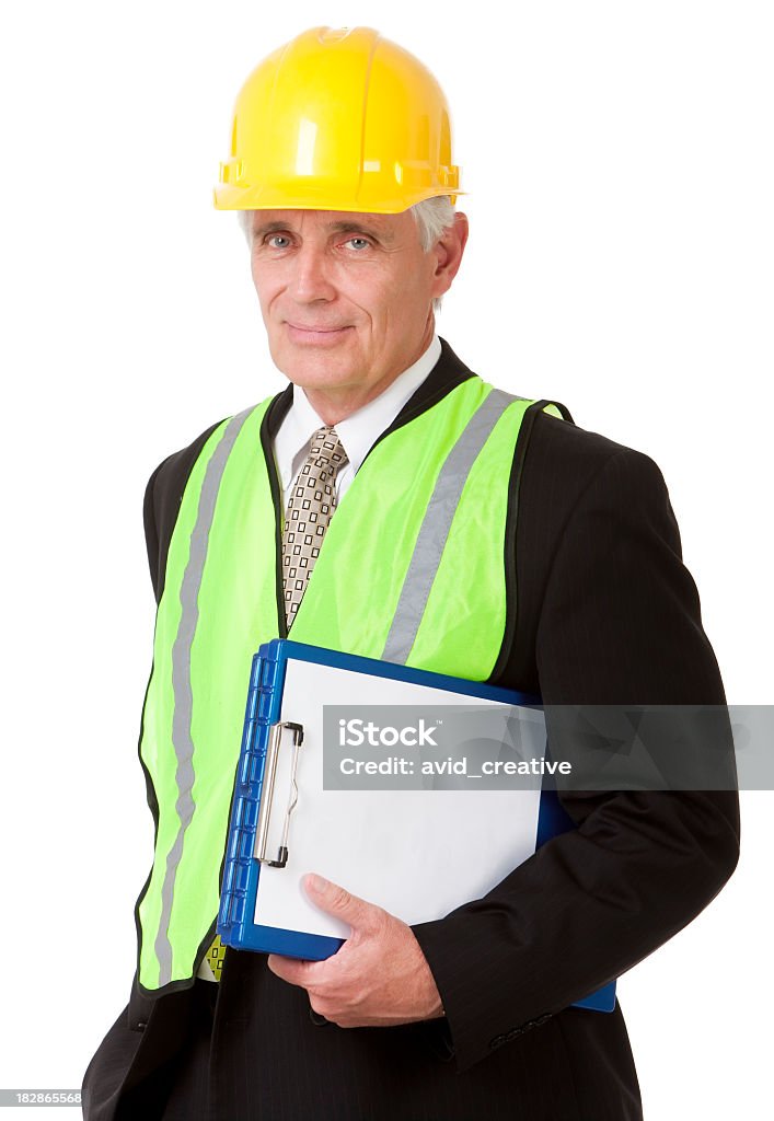 Mature Safety Engineer Portrait of a handsome 50-year old businessman in a suit, hardhat and safety vest holding a clipboard. Isolated on a pure white background. White Background Stock Photo