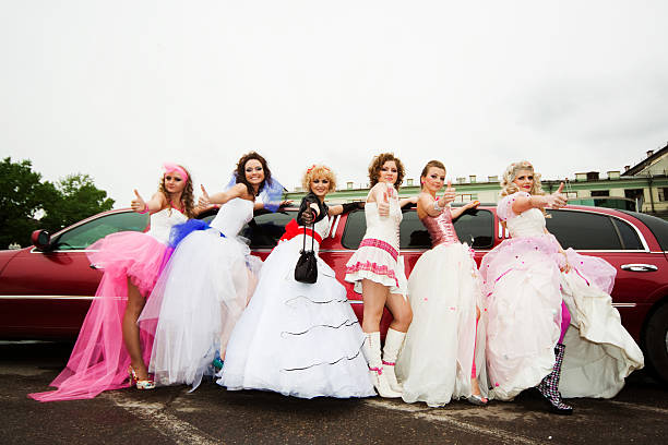 Brides near limousine