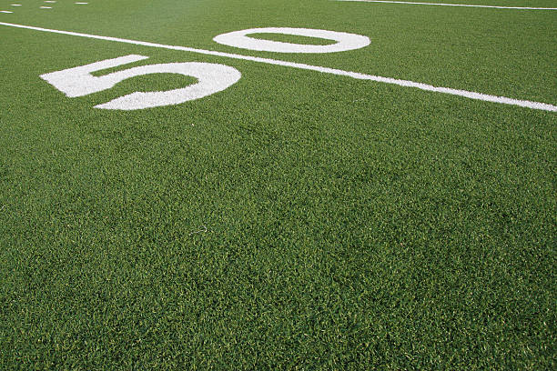 istock Football Field 50-Yard Line Artificial Grass Turf Angled View 182865969