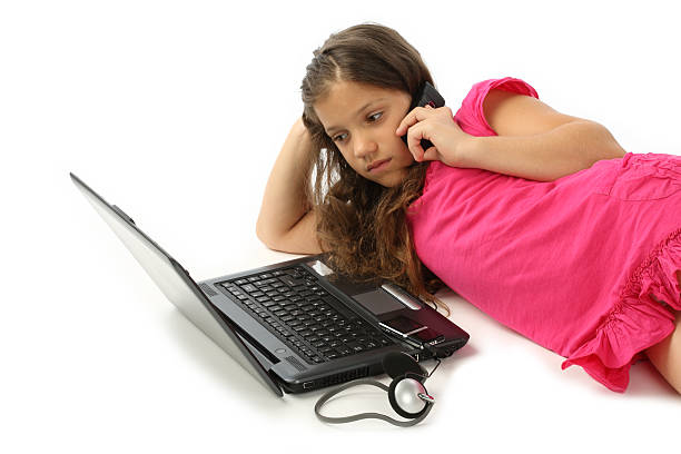 menina falando no telefone mobil deitado antes de laptop - lying on side audio - fotografias e filmes do acervo