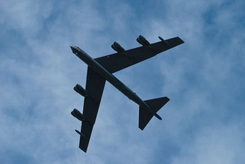 The distinctive silhouette of a B-52 Bomber flying overhead.