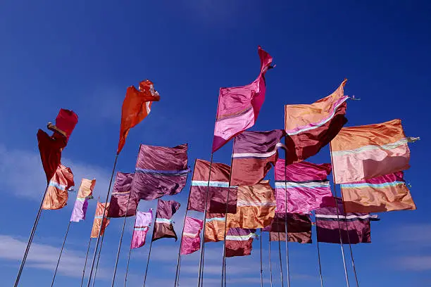 Lovely silk festival flags blowing in the wind.slight movement.fast shutter speed and polarised for deep colour.